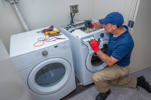 Technician repairing a washing machine.
